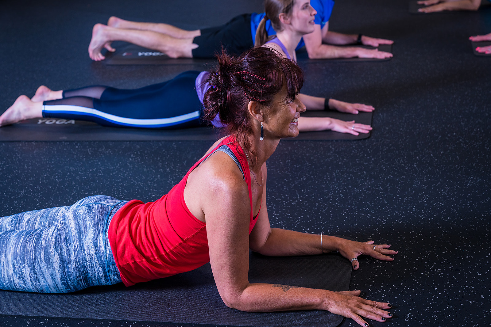 A group of women and men participating in a gentle yoga class at Christchurch Recreation and Sport.