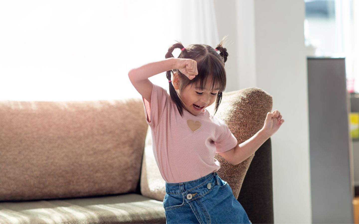 A young girl dancing in a lounge. 
