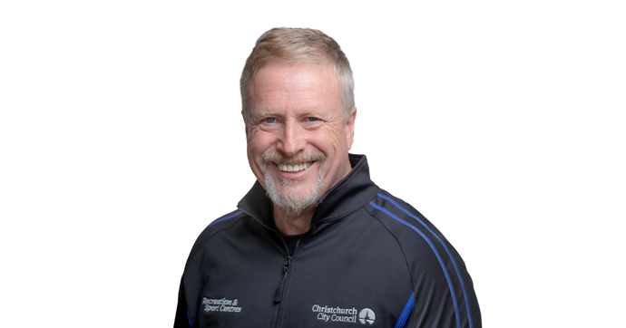 Smiling Personal Trainer, Stuart Dallow wearing and blue and black staff uniform. 