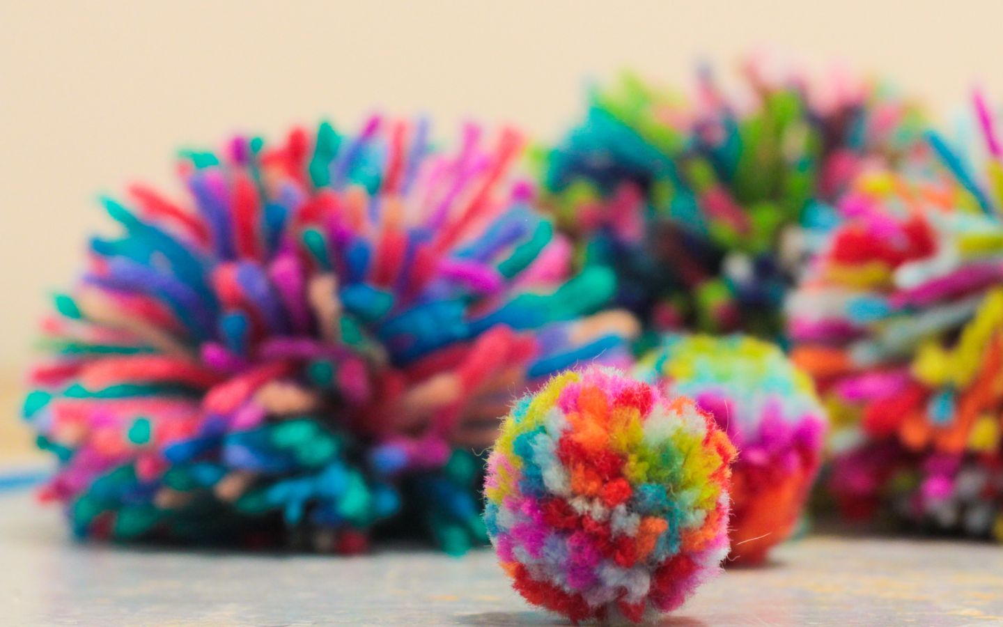 Multicoloured fluffy pom poms. 
